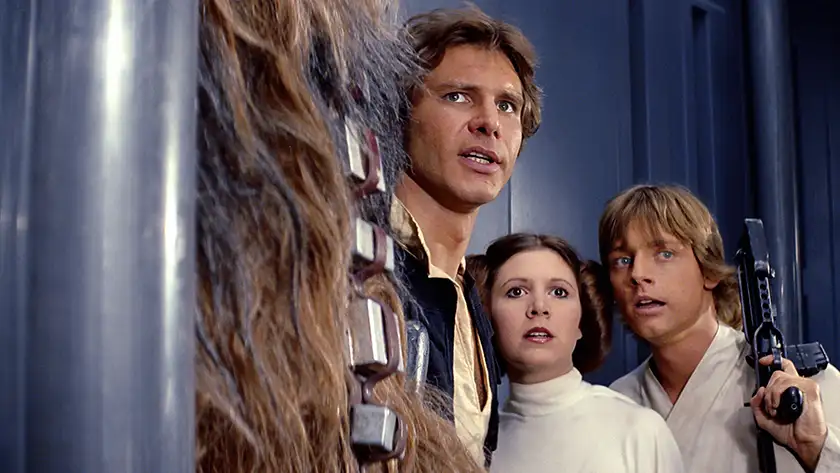 Han Solo, Leia Organa, Luke Skywalker and Chewbacca hide in a corridor in Star Wars Episode IV: A New Hope