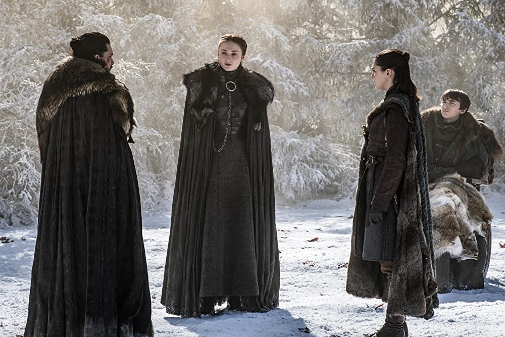 Kit Harington, Maisie Williams, Isaac Hempstead Wright, and Sophie Turner stand outside in the snow in Game of Thrones 