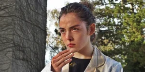 Justine (Garance Marillier) holds out a hand and bleeds from her nose in a still from the movie "Raw"