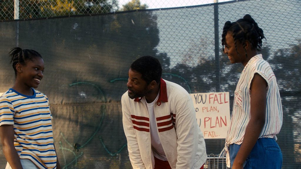 (L-r) DEMI SINGLETON as Serena Williams, WILL SMITH as Richard Williams and SANIYYA SIDNEY as Venus Williams in Warner Bros. Pictures’ inspiring drama “KING RICHARD" 