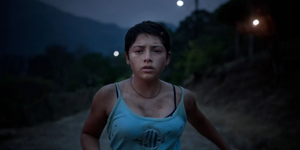 a young girl runs in the street in the film Prayers for the Stolen