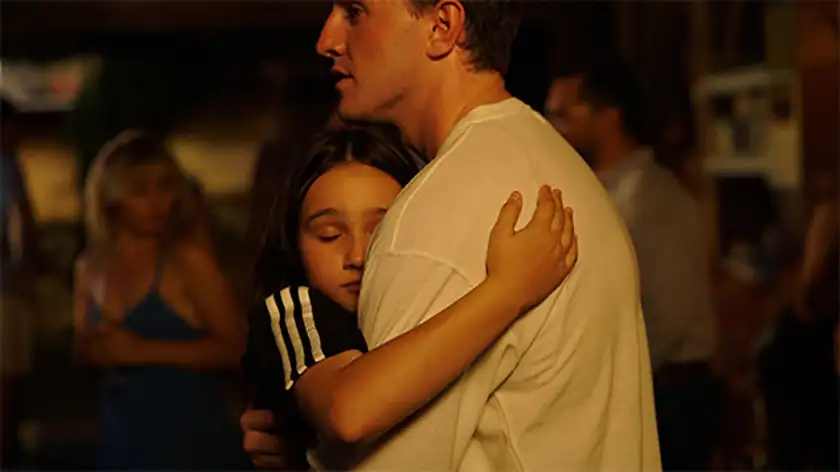 Callum and Sophie hug in the film Aftersun by Charlotte Wells