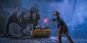 Actor Sam Neill as Dr. Alan Grant and a t-rex in a scene from the film Jurassic Park, 1993