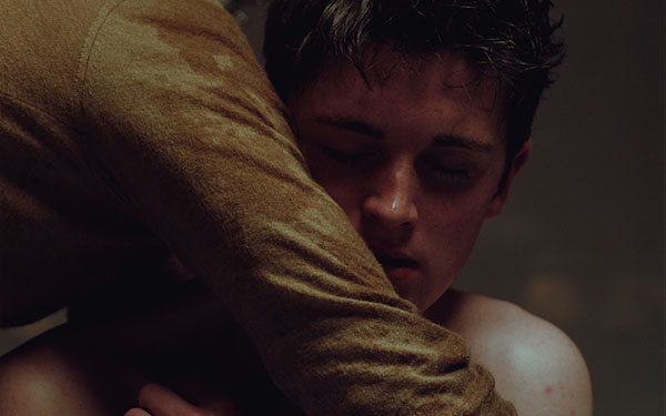 two characters hug in the film It Is In Us All