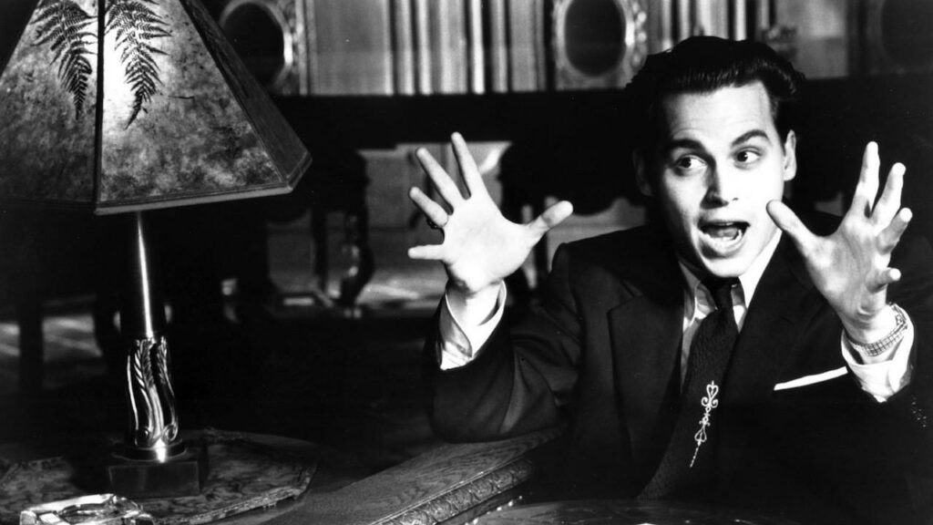 Johnny Depp raises his hands in the air in the film Ed Wood