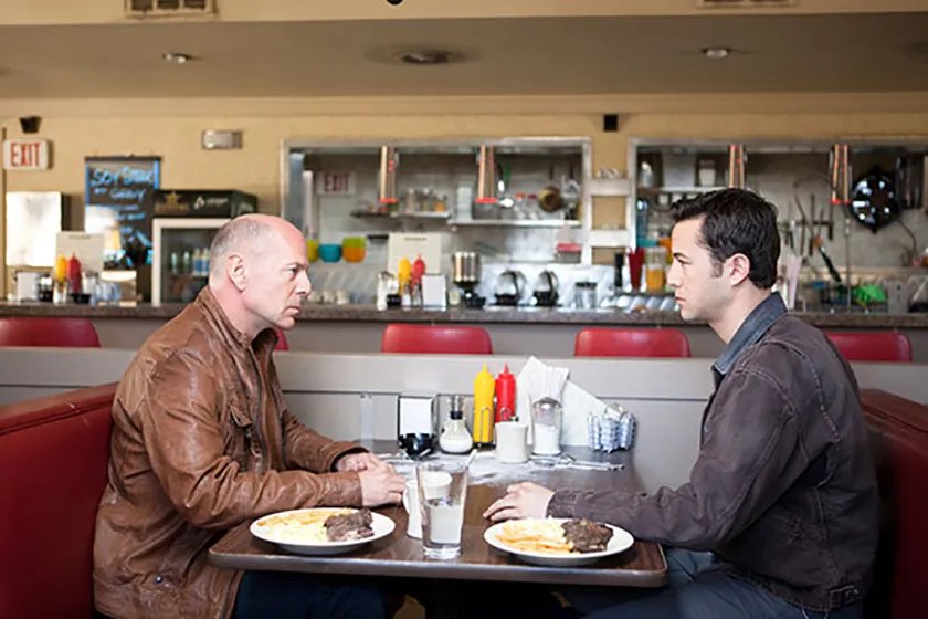Bruce Willis and Joseph Gordon-Levitt as "Joe" in Looper, one of all the Rian Johnson movies ranked from worst to best by Loud And Clear Reviews