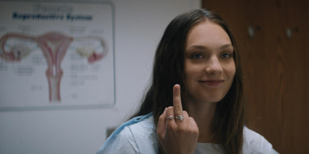 Ziegler raises her middle finger in the film Fitting In, previously titled Bloody Hell