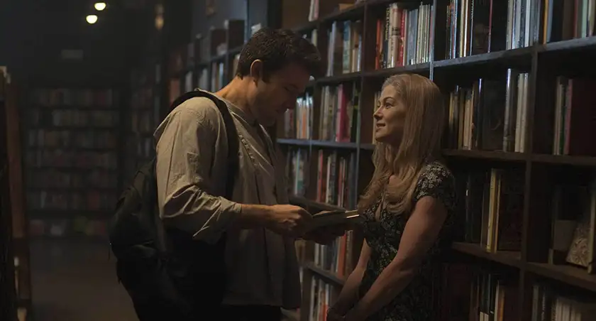 Rosamund Pike and Ben Affleck are at the library in a still from the movie Gone Girl