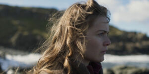 A woman looks at the horizon outdoors in a still from the film A Letter From Helga