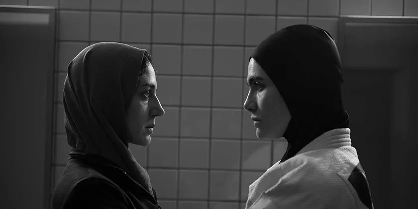 Zar Amir Ebrahimi and Arienna Mandi look at each other in the film Tatami