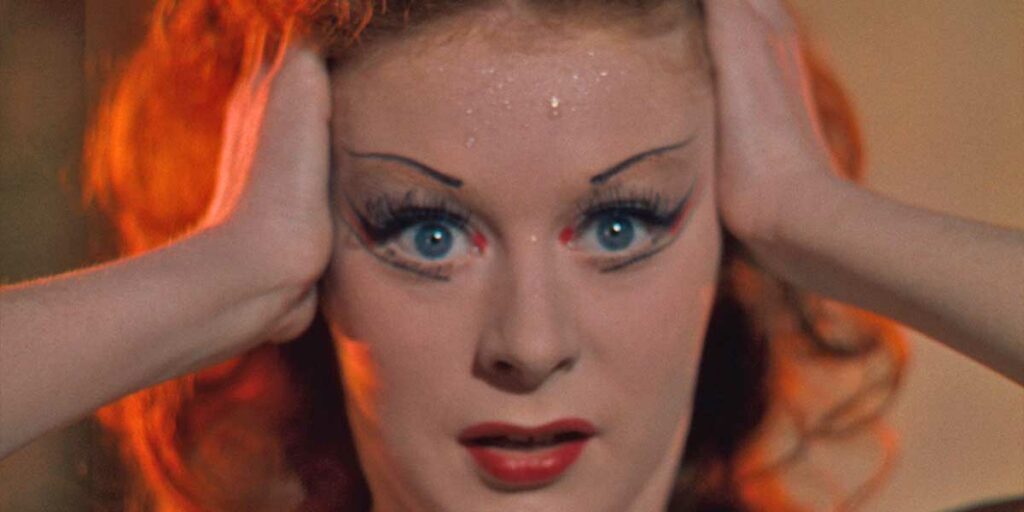 A woman looks upset and wide eyed in the film The Red Shoes
