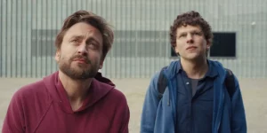 Kieran Culkin and Jesse Eisenberg look up in the film A Real Pain