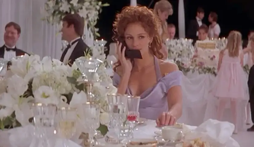 rom-coms to watch if you liked Anyone But You: My Best Friend's Wedding julia roberts at table