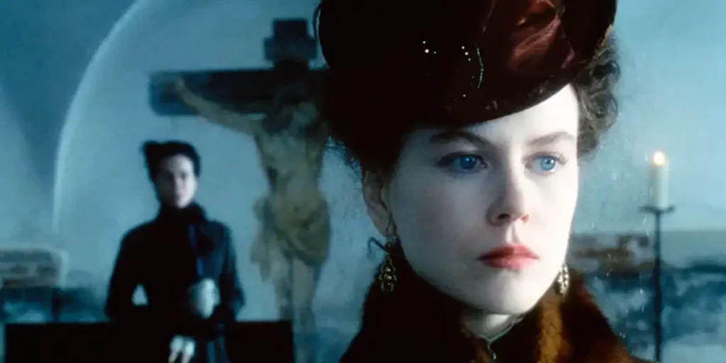 Nicole Kidman in The Portrait of a Lady, looking away with a crucifix behind her