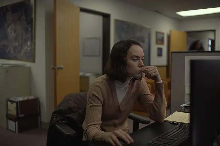Daisy Ridley sits at the computer in a scene from Sometimes I Think About Dying, from director Rachel Lambert and starring Dave Merheje