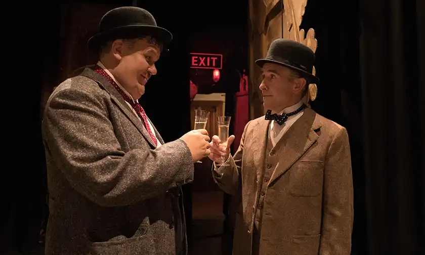 John C. Reilly and Steve Coogan in Stan & Ollie, clinking glasses