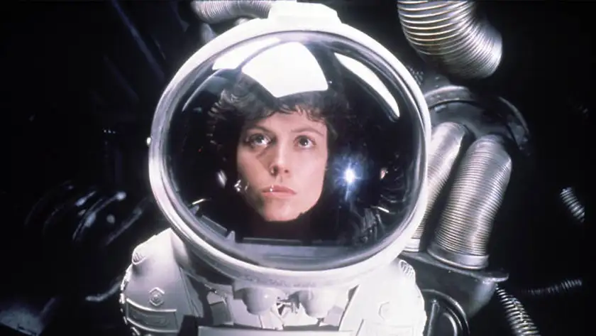 Sigourney Weaver stares at the camera dressed as an astronaut in the film Alien (1979)