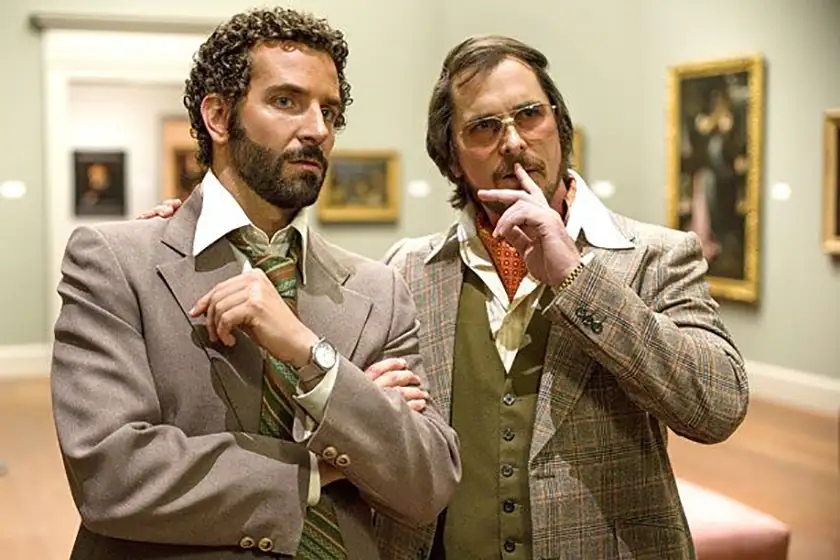 Bradley Cooper and Christian Bale look puzzled in the film American Hustle