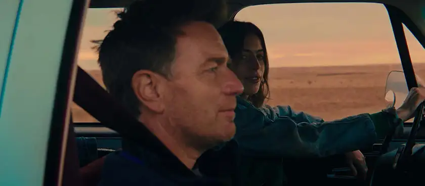 Clara McGregor drives a car and looks at her father Ewan sitting next to her in the film Bleeding Love
