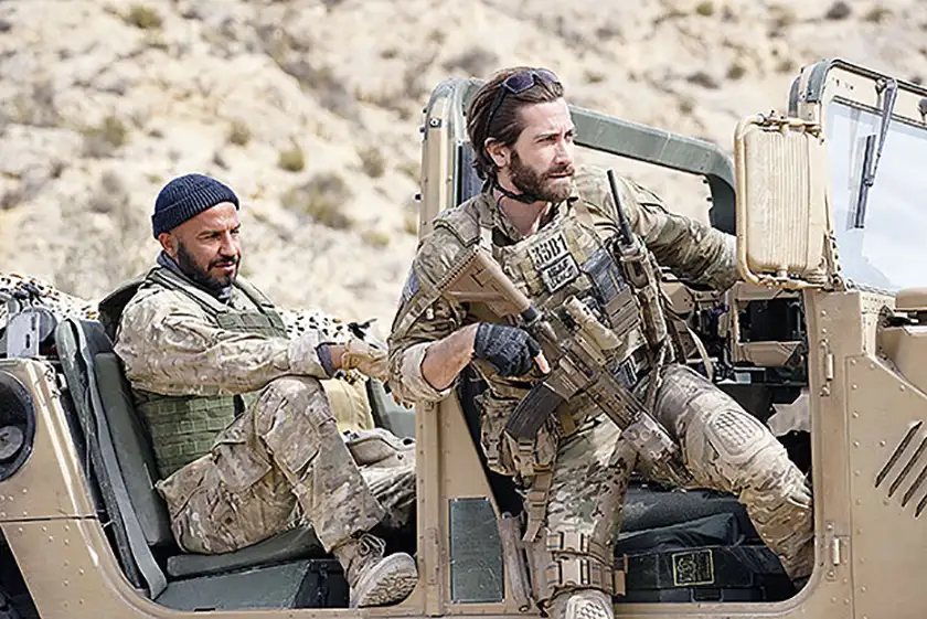 Jake Gyllenhaal and Dar Salim stand in a military truck in Guy Ritchie's The Covenant