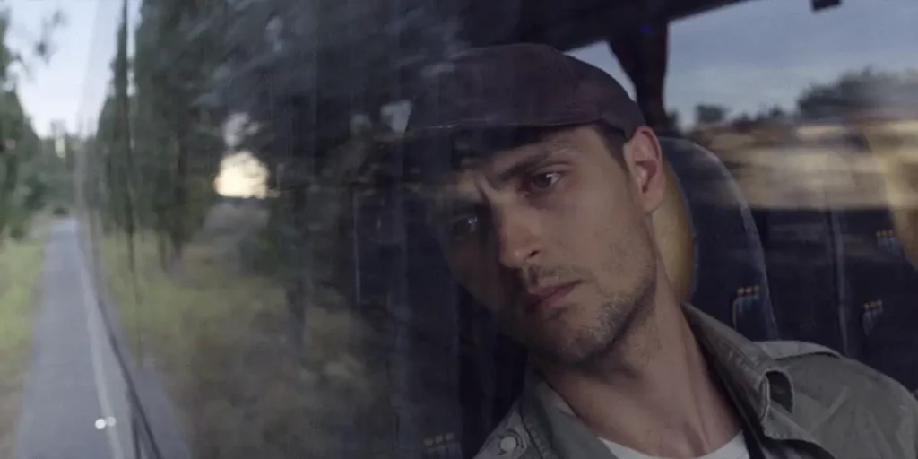 Dmytro Bahnenko looks out of the window in the film The Editorial Office (Redaktsiya)