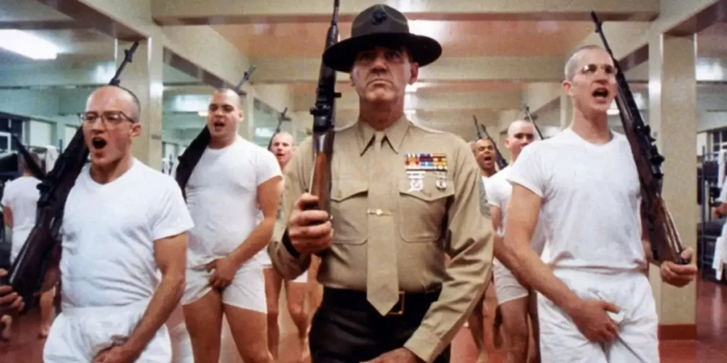 The sergeant and trainees stand holding rifles in one of the most famous scenes from the film Full Metal Jacket