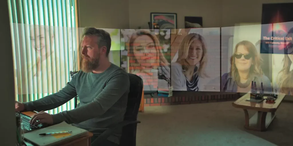 A still Dave, from Netflix documentary Lover Stalker Killer, sitting at his computer with his potential matches behind him