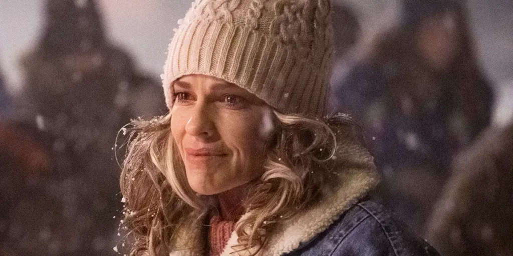 Hilary Swank wears a warm hat and smiles in the film Ordinary Angels
