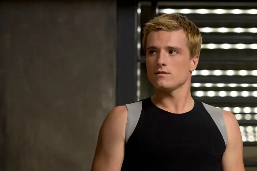 Josh Hutcherson looks to his right while wearing training gear as Peeta Mellark in the film Catching Fire