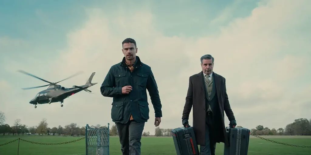 Two men walk toward the camera with a helicopter leaving in the background in the 2024 Netflix series The Gentlemen