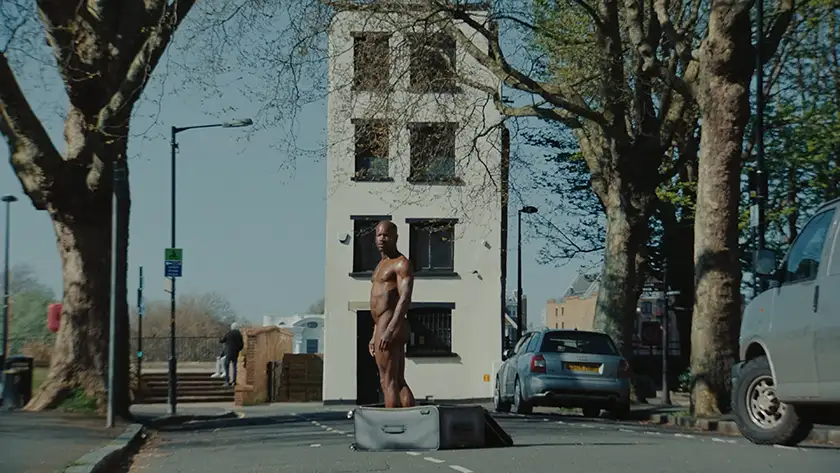 a man comes out of a suitcase in Bruce LaBruce film The Visitor, from loud and clear reviews