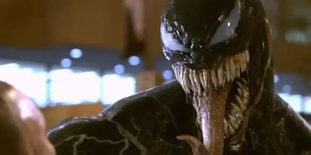 Venom smiles with its tongue out in the film Venom