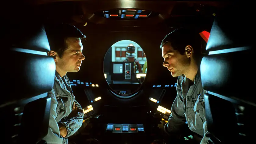 Two characters on a spaceship with HAL in the middle in the film 2001: A Space Odyssey