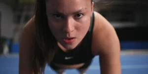 A young girl does sit ups in the film Backspot