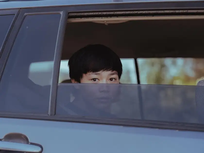 Izaac Wang inside a car on set of the film Dìdi
