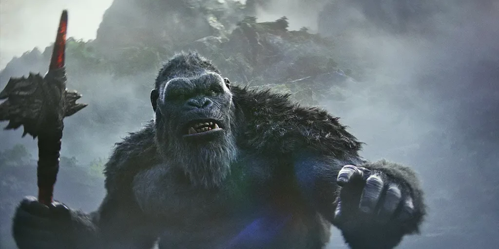 King Kong holds an axe in front of some mountains in the film “GODZILLA x KONG: THE NEW EMPIRE"