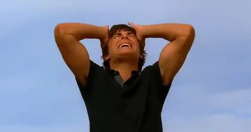 Zac Efron has his hands on his face in one of the best scenes from High School Musical 2