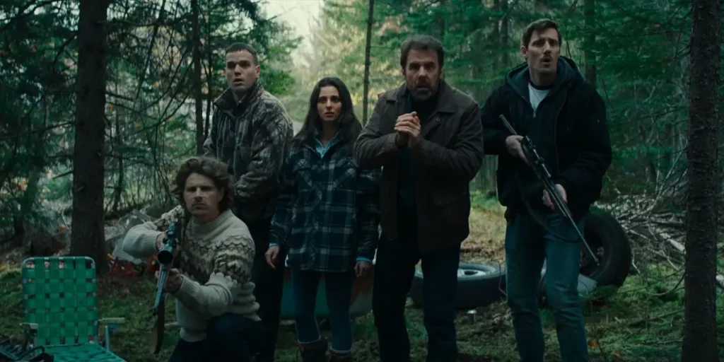 A group of people in the forest in the film Hunting Daze