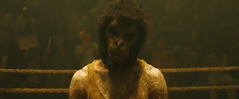 Dev Patel wears a monkey mask in the ring in the film Monkey Man