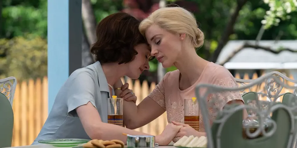 Jessica Chastain and Anne Hathaway share a moment with their heads close to one another in the film Mothers' Instinct