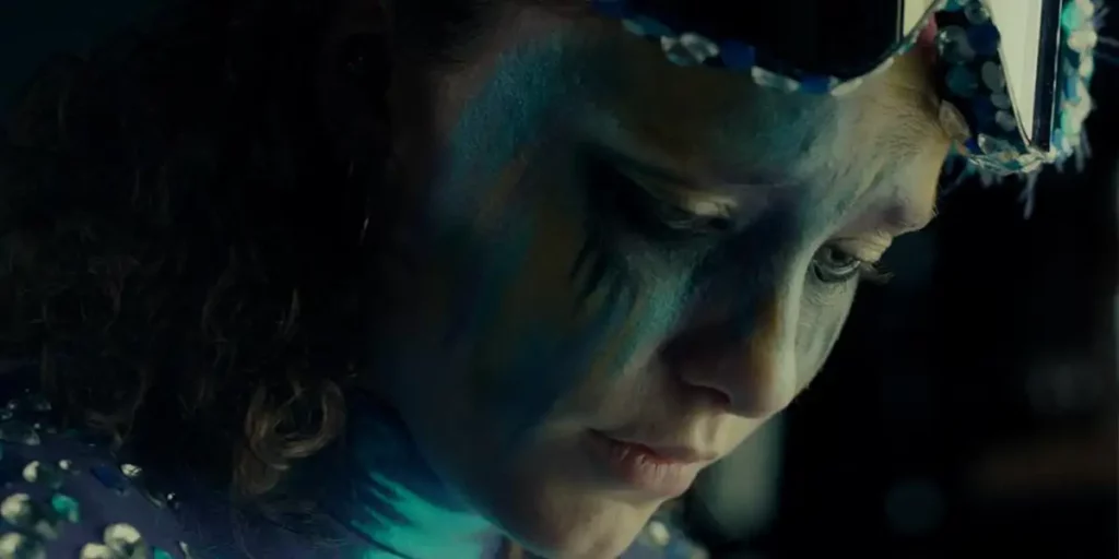 The closeup of a young woman with a painted face in the film Natatorium