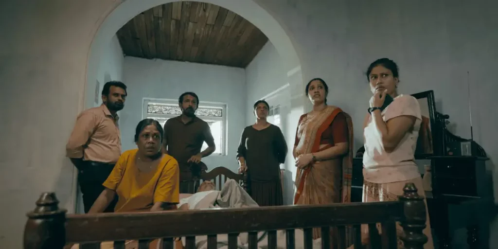 Six people look at the camera from a rail inside a house in a shot from the film Tentigo