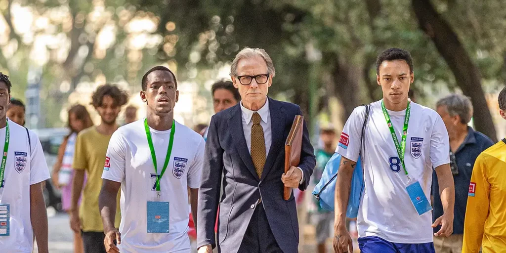 Bill Nighy, Michael Ward and other football players walk determined in Netflix film The Beautiful Game