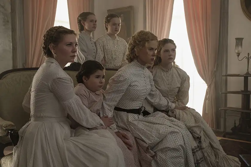 A group of women sit close together in the film The Beguiled
