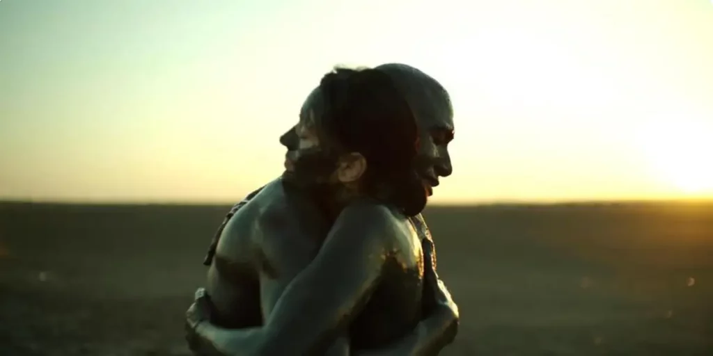 A man and a woman hug each other outdoors in the film The Black Sea
