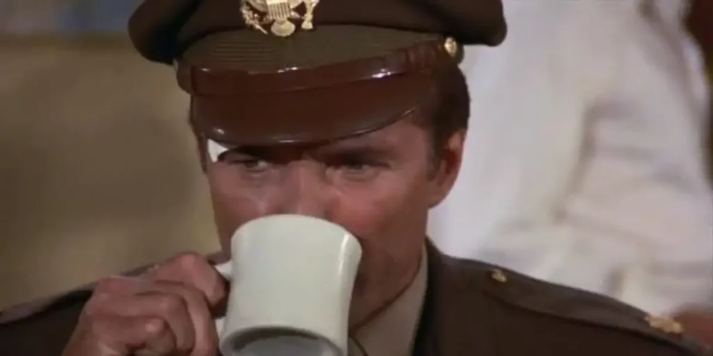 A man drinks coffee in Episode 9 of Wonder Woman (1975)