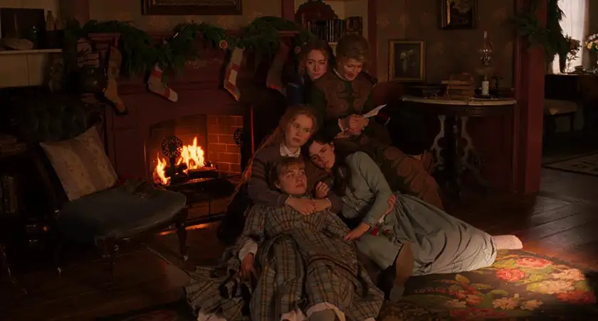 The March sisters sit by the fire in Little Women, one of the movies directed by Greta Gerwig ranked from worst to best by Loud and Clear Reviews