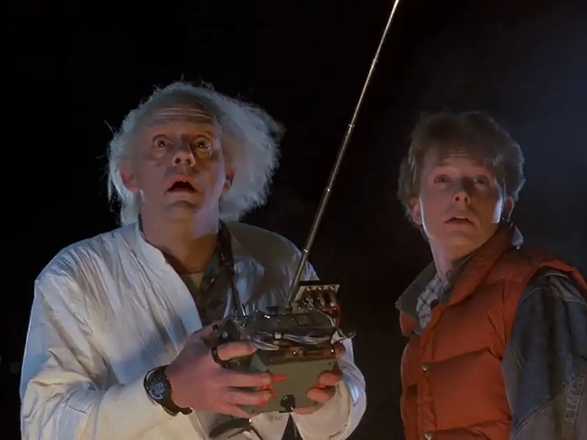 Doc Brown holds a transmitter and Marty McFly stands next to him in Back to the Future, one of the 5 Age Appropriate Movies for 12 Year Olds recommended by Loud and Clear Reviews
