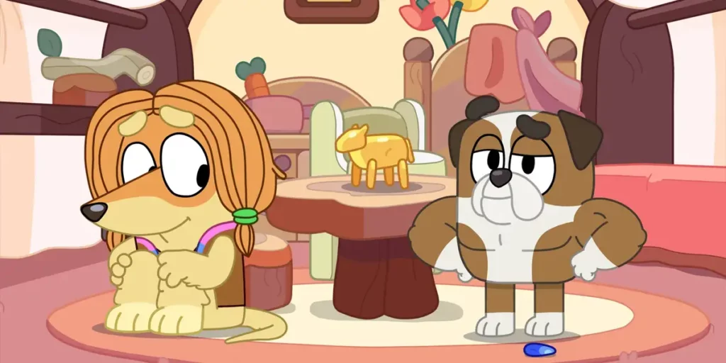 Two of the supporting characters of the series Bluey - a yellow dog with long hair and a pitbull - stand next to a table with a statue on it in an episode of the show