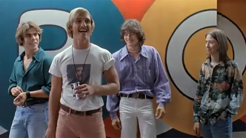 The four main characters of Dazed and Confused - one of the 10 must-see stoner movies to watch on 420 - stand in front of a multicolor wall